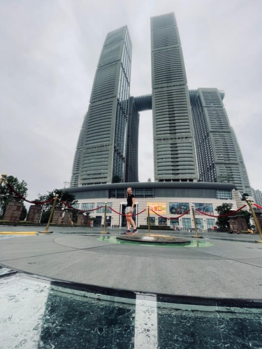 Andrea walking past the zero kilometre marker in Chongqing