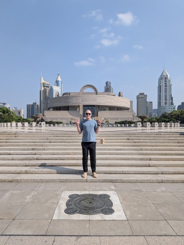 Chris Brown stood behind the Zero Kilometer marker in Shanghai